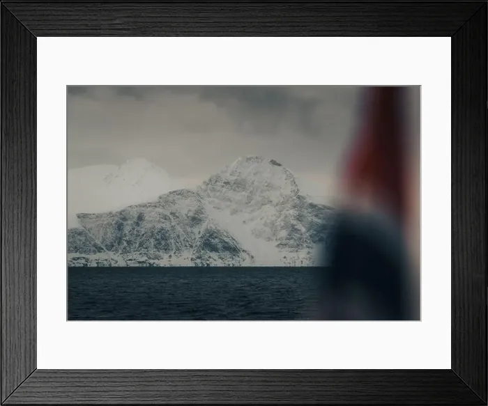 Framed Print : Snowy mountain behind Norwegian flag in the arctic Lyngen Alps in Norway, winter Framed Print : Snowy mountain behind Norwegian flag in the arctic Lyngen Alps in Norway, winter