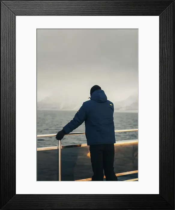 Framed Print : Man stood on arctic tour boat looking at distant mountains in northern Norway Framed Print : Man stood on arctic tour boat looking at distant mountains in northern Norway