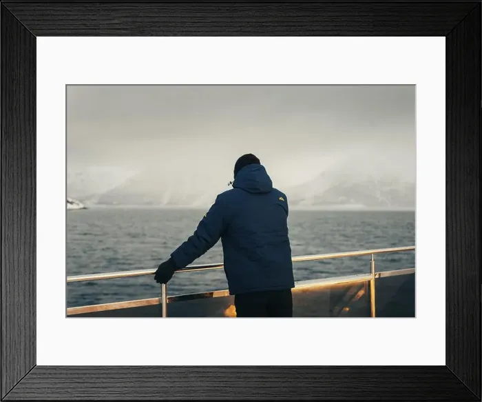 Framed Print : Man in blue coat stood on boat looking at misty Lyngen Alps in Norway winter Framed Print : Man in blue coat stood on boat looking at misty Lyngen Alps in Norway winter