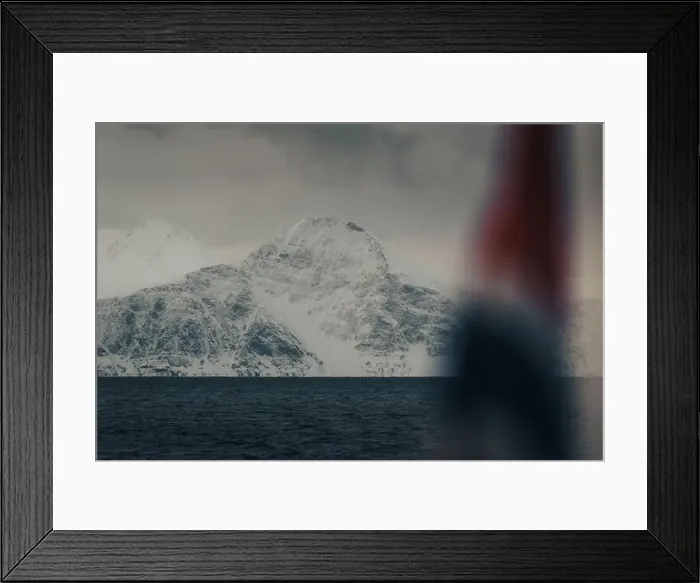 Framed Print : Snowy mountain behind Norwegian flag in the arctic Lyngen Alps in winter Framed Print : Snowy mountain behind Norwegian flag in the arctic Lyngen Alps in winter