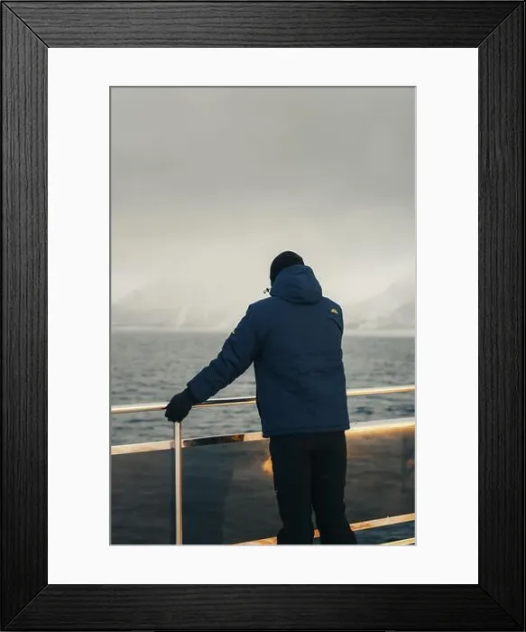 Framed Print : Man stood at arctic tour boat railing looking at distant Lyngen Alps, Norway Framed Print : Man stood at arctic tour boat railing looking at distant Lyngen Alps, Norway