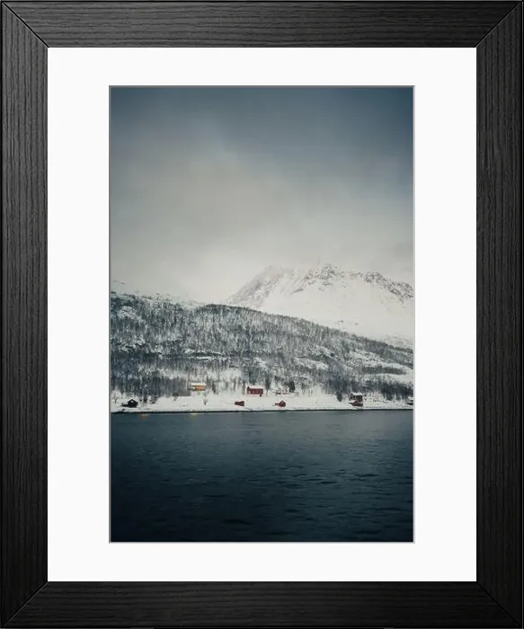 Framed Print : Cabins on the snowy bank by the arctic ocean in the Lyngen Alps in Norway Framed Print : Cabins on the snowy bank by the arctic ocean in the Lyngen Alps in Norway