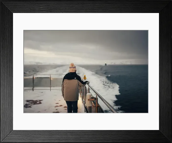 Framed Print : Woman stood holding boat rail on Norwegian fjord in the arctic Framed Print : Woman stood holding boat rail on Norwegian fjord in the arctic