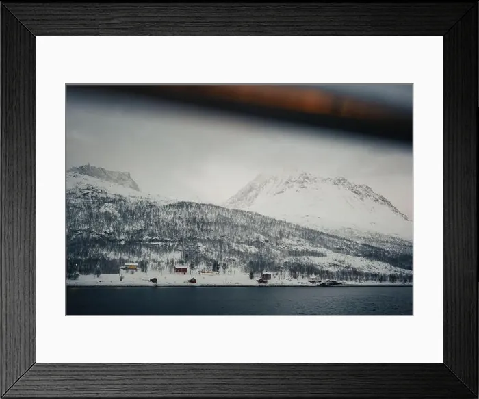 Framed Print : Cabins in winter in the snowy Lyngen Alps by the arctic ocean in Norway Framed Print : Cabins in winter in the snowy Lyngen Alps by the arctic ocean in Norway
