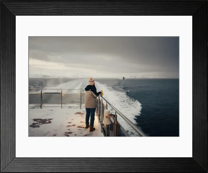 Framed Print : Woman holding snowy boat railing on Norwegian fjord near Tromso Framed Print : Woman holding snowy boat railing on Norwegian fjord near Tromso