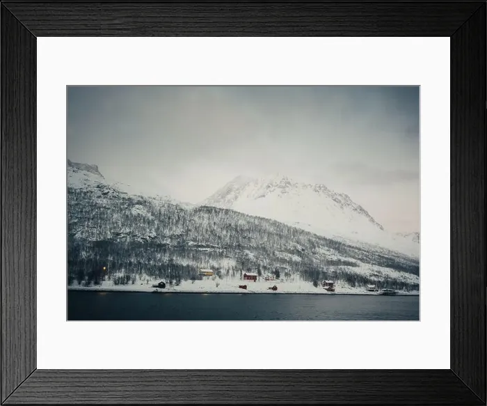 Framed Print : Red wooden cabins in the snowy Lyngen Alps by the arctic ocean in Norway Framed Print : Red wooden cabins in the snowy Lyngen Alps by the arctic ocean in Norway