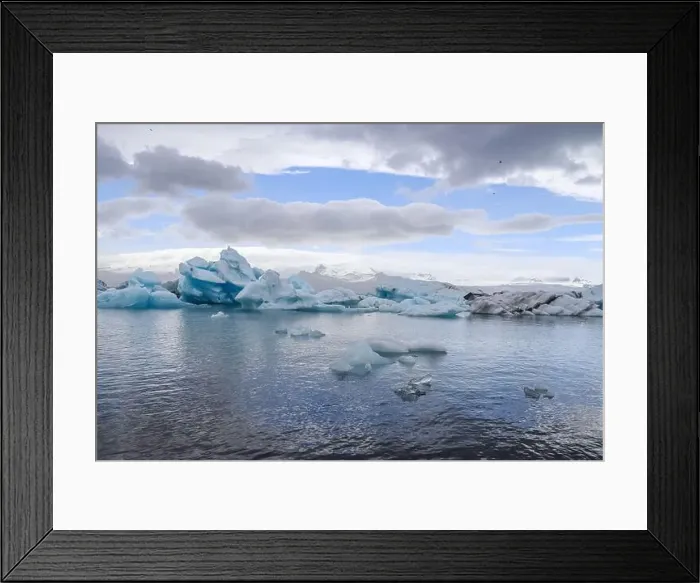 Framed Print : Icebergs are floating in jokulsarlon glacier lagoon in iceland, creating a breathtaking view under a cloudy sky