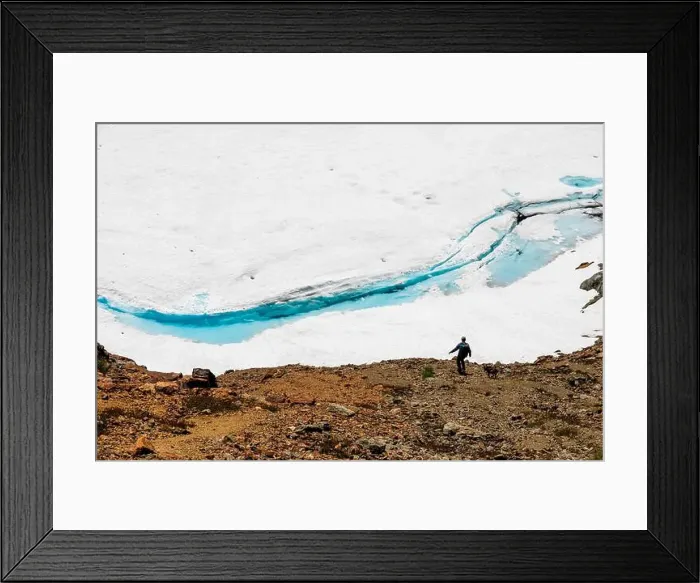 Framed Print : Hiker and dog along Glacial Snowfield with Vibrant Blue Meltwater Framed Print : Hiker and dog along Glacial Snowfield with Vibrant Blue Meltwater
