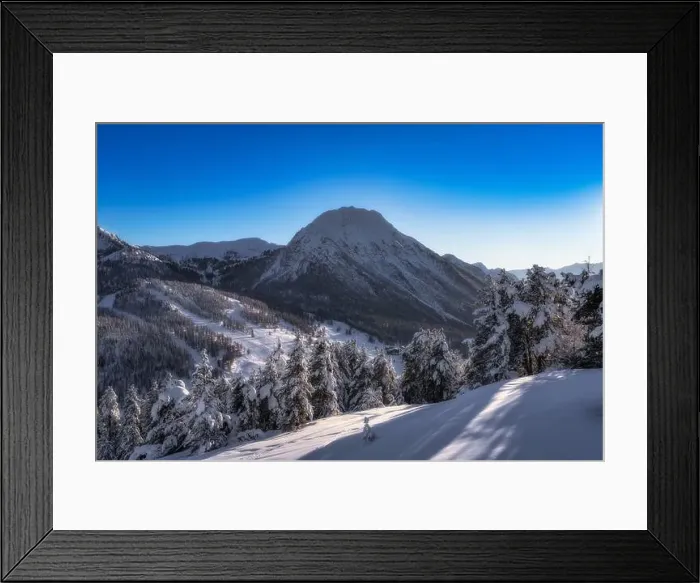 Framed Print : A breathtaking winter scene beautifully showcases majestic snowcovered mountains and trees Framed Print : A breathtaking winter scene beautifully showcases majestic snowcovered mountains and trees