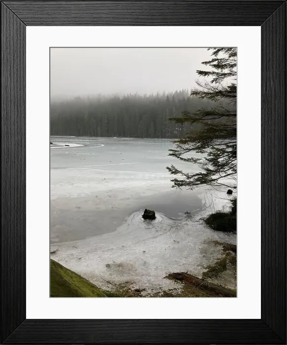 Framed Print : A serene pond surrounded by snow-covered trees and majestic rocks Framed Print : A serene pond surrounded by snow-covered trees and majestic rocks