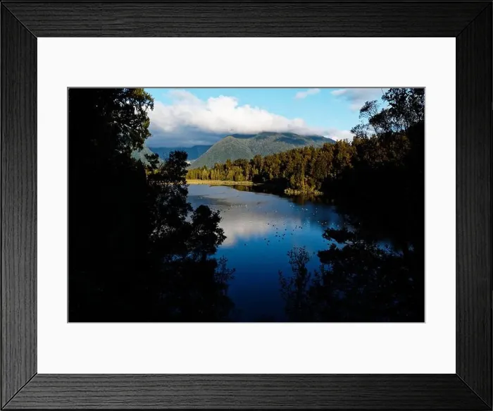 Framed Print : Lake Matheson is nestled in ancient forest and is famous for mirror views of Aoraki / Mount Cook and Mount Tasman Framed Print : Lake Matheson is nestled in ancient forest and is famous for mirror views of Aoraki / Mount Cook and Mount Tasman