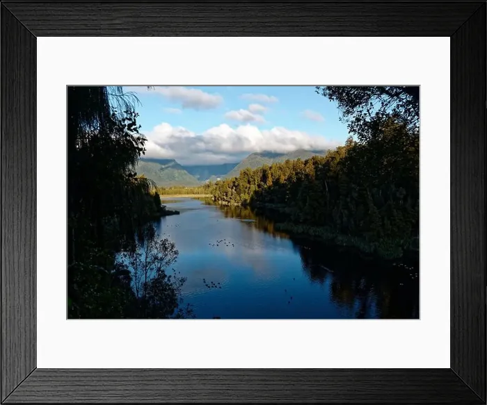 Framed Print : Lake Matheson stretches into the distant hills while waterfowl rest on its surface Framed Print : Lake Matheson stretches into the distant hills while waterfowl rest on its surface