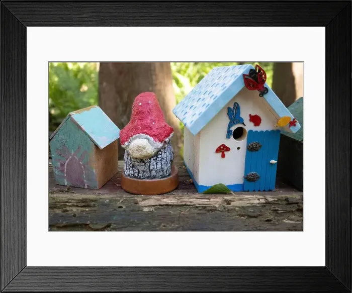 Framed Print : Collection of birdhouses made by children and placed on fallen trees in the forest Framed Print : Collection of birdhouses made by children and placed on fallen trees in the forest