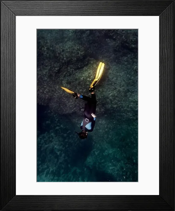 Framed Print : A diver descends into the clear, blue waters of Menorca, Spain, surrounded by rocky underwater terrain Framed Print : A diver descends into the clear, blue waters of Menorca, Spain, surrounded by rocky underwater terrain