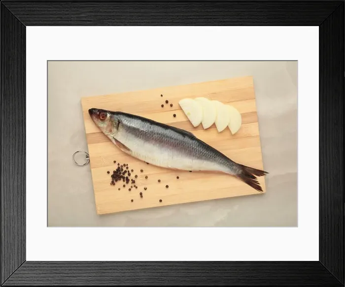 Framed Print : Fresh herring fish on cutting board on grey background. Top view Framed Print : Fresh herring fish on cutting board on grey background. Top view