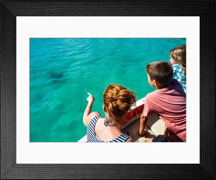 Framed Print : View of a family on a boat waiting for sea turtle to break through the water surface near Mauritius Framed Print : View of a family on a boat waiting for sea turtle to break through the water surface near Mauritius
