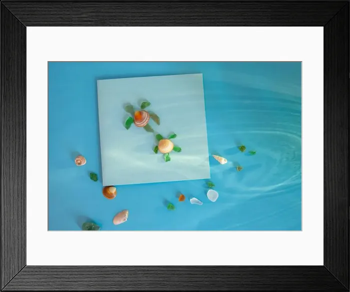Framed Print : Creative turtle shape made from sea glass and seashell on blue background Framed Print : Creative turtle shape made from sea glass and seashell on blue background