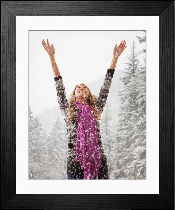 Framed Print : Mixed race woman playing in snow Framed Print : Mixed race woman playing in snow