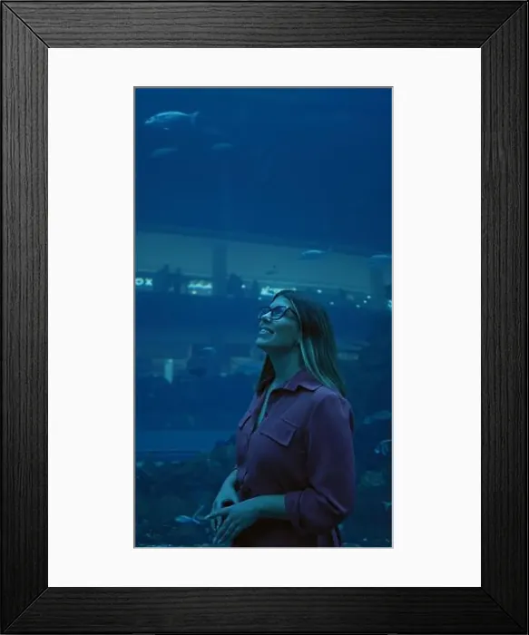 Framed Print : A smiling woman enjoys the view at an underwater aquarium in dubai, surrounded by marine life Framed Print : A smiling woman enjoys the view at an underwater aquarium in dubai, surrounded by marine life