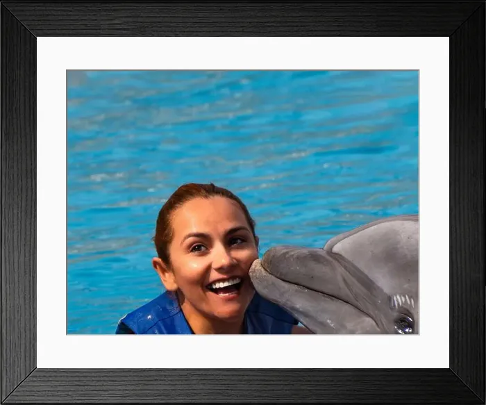 Framed Print : An Happy red hair latina girl swimming with a dolphin Framed Print : An Happy red hair latina girl swimming with a dolphin