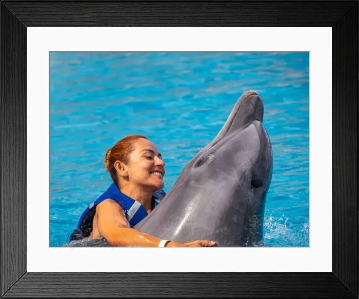 Framed Print : An Happy red hair latina girl swimming with a dolphin
