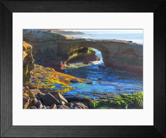 Framed Print : Vibrant natural arch formation frames lively tide pools along the rugged coastline of San Diego Framed Print : Vibrant natural arch formation frames lively tide pools along the rugged coastline of San Diego