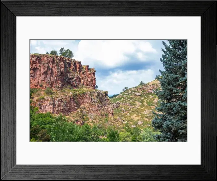 Framed Print : Lush greenery surrounds dramatic red rock formations under a vibrant cloudy sky in the mountains of Colorado USA Framed Print : Lush greenery surrounds dramatic red rock formations under a vibrant cloudy sky in the mountains of Colorado USA