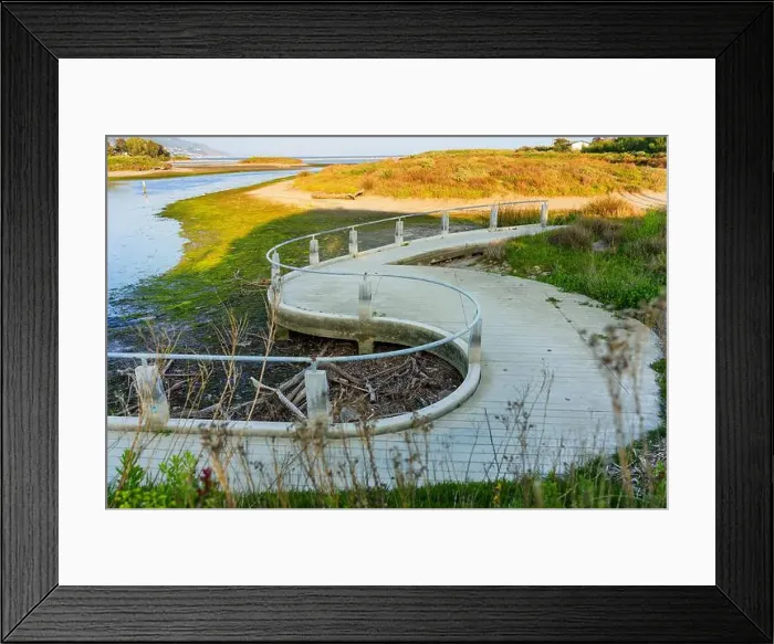 Framed Print : Winding boardwalk surrounded by greenery and water at Malibu Lagoon in California. Coastal landscape Framed Print : Winding boardwalk surrounded by greenery and water at Malibu Lagoon in California. Coastal landscape