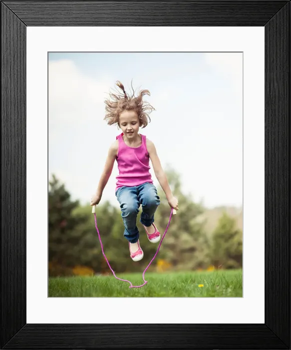 Framed Print : Young girl skipping in park Framed Print : Young girl skipping in park