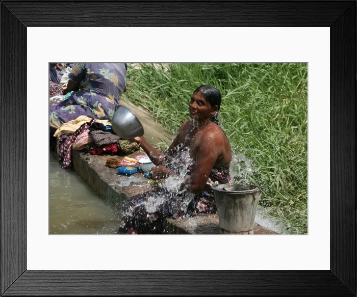 Framed Print : Woman bathing in the rural countryside of Sri Lanka Framed Print : Woman bathing in the rural countryside of Sri Lanka