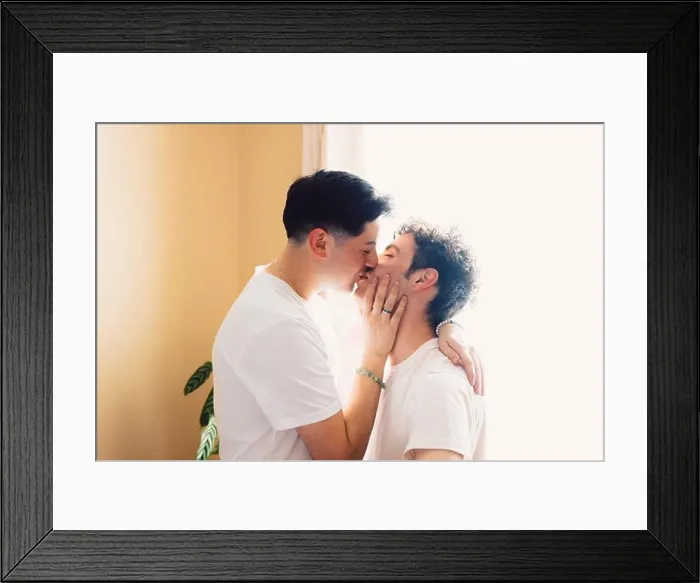 Framed Print : Gay couple romantically kissing on the mouth, in the living room. LGBT relationship and routine Framed Print : Gay couple romantically kissing on the mouth, in the living room. LGBT relationship and routine
