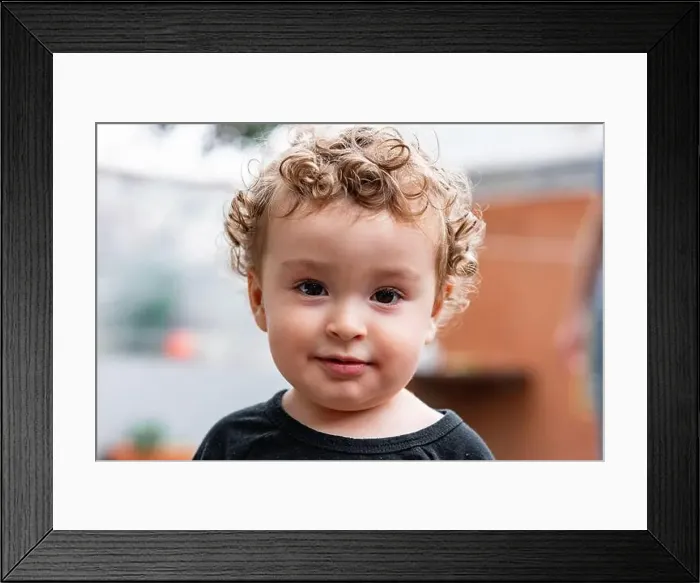 Framed Print : Adorable little kid with blond curly hair and brown eyes looking at camera on blurred background Framed Print : Adorable little kid with blond curly hair and brown eyes looking at camera on blurred background