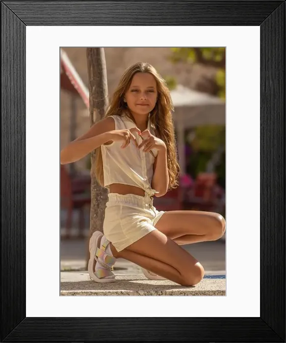Framed Print : This image is a heartwarming portrait of an 11-year-old girl, capturing a moment of pure joy and innocence