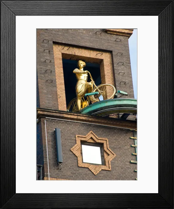 Framed Print : Fragment of building and statue of woman with bicycle in Copenhagen, Denmark Framed Print : Fragment of building and statue of woman with bicycle in Copenhagen, Denmark