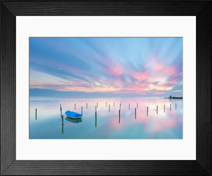 Framed Print : A beautiful calm and tranquil sunset with bright blue and pink colors Framed Print : A beautiful calm and tranquil sunset with bright blue and pink colors