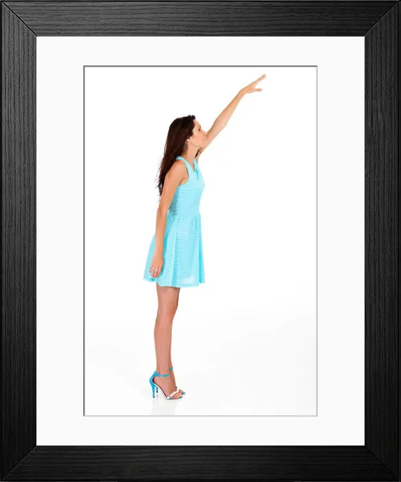 Framed Print : tall young woman reaching for something high Framed Print : tall young woman reaching for something high