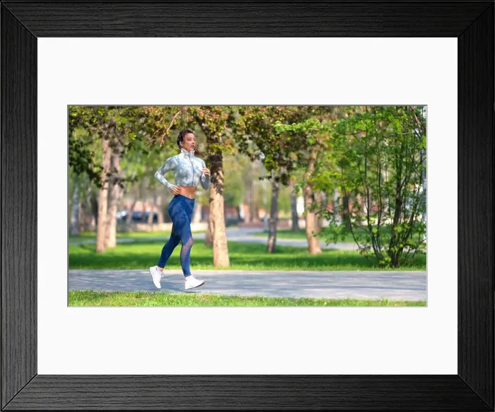 Framed Print : Full length photo of a woman running in park in early morning Framed Print : Full length photo of a woman running in park in early morning