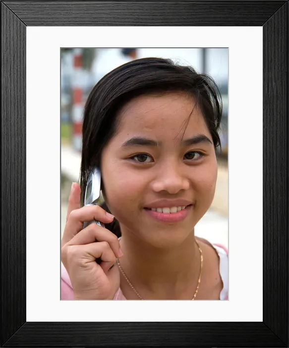 Framed Print : Portrait of a Vietnamese girl using a cell phone in Hue Vietnam Framed Print : Portrait of a Vietnamese girl using a cell phone in Hue Vietnam