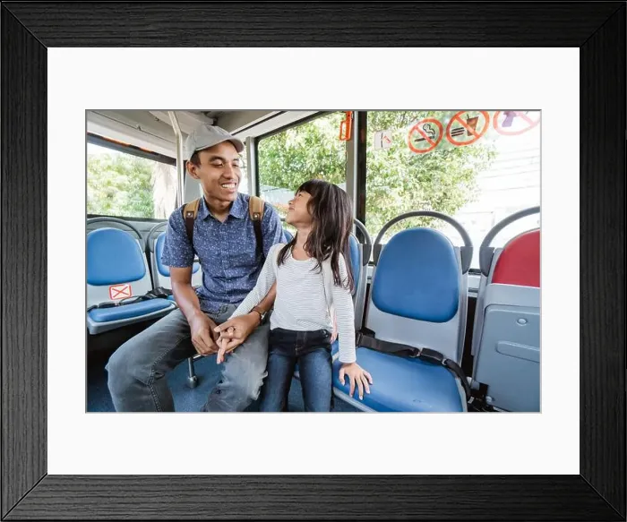 Framed Print : asian father taking his daughter to school by riding bus public transport Framed Print : asian father taking his daughter to school by riding bus public transport