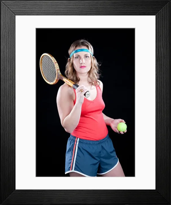 Framed Print : Funny retro female tennis player holds racket and ball, appears ready to play Framed Print : Funny retro female tennis player holds racket and ball, appears ready to play
