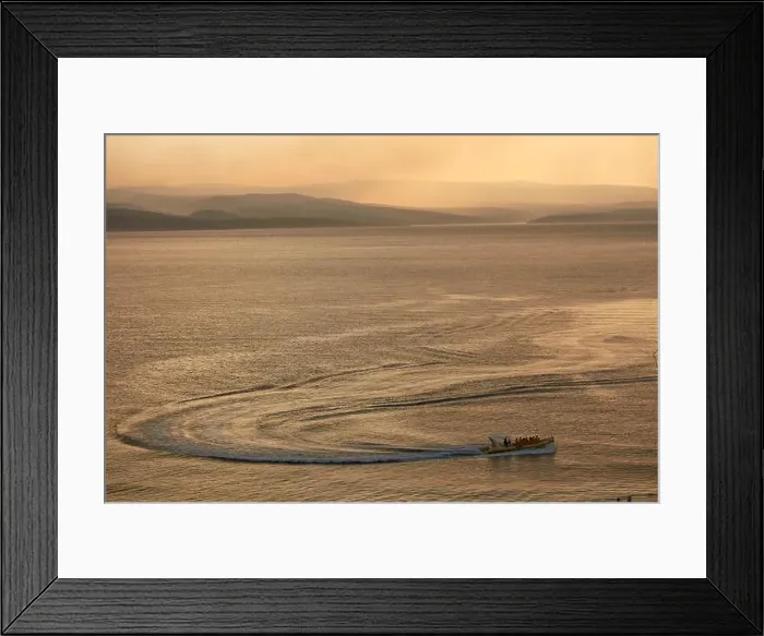 Framed Print : A boat with passengers on calm, golden water at sunset, distant islands, hazy sun, wide shot. Croatia Framed Print : A boat with passengers on calm, golden water at sunset, distant islands, hazy sun, wide shot. Croatia