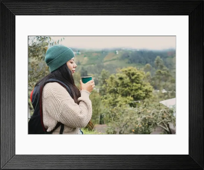 Framed Print : A woman sips her warm coffee outdoors, surrounded by the serene beauty of nature and majestic mountains Framed Print : A woman sips her warm coffee outdoors, surrounded by the serene beauty of nature and majestic mountains