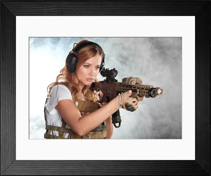 Framed Print : Girl marksman in sniper gear holding sniper rifle in hand aiming at enemys head in dark smoky background Framed Print : Girl marksman in sniper gear holding sniper rifle in hand aiming at enemys head in dark smoky background