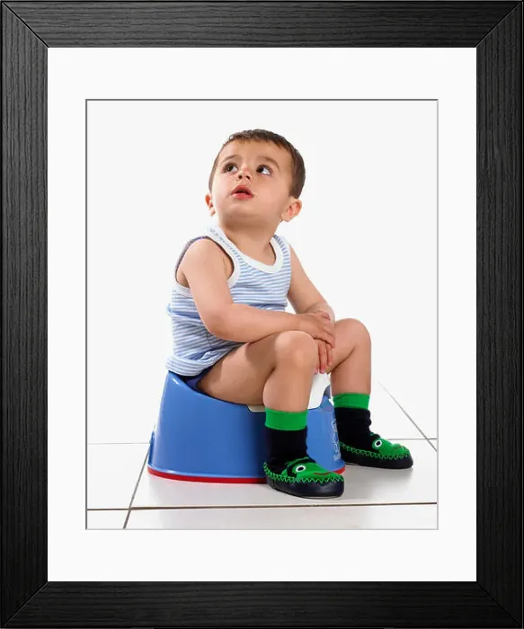 Framed Print : Boy wearing vest and slippers, sitting on potty, 15 months Framed Print : Boy wearing vest and slippers, sitting on potty, 15 months