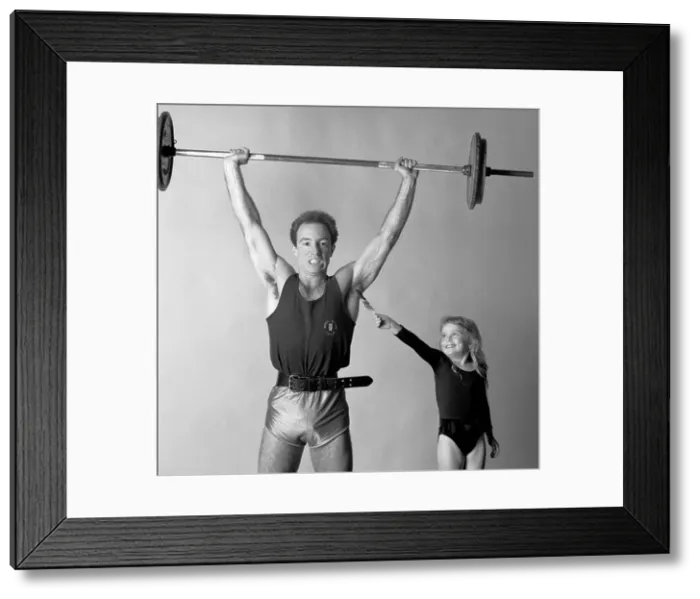 Framed Print : Little girl tickling bodybuilder Framed Print : Little girl tickling bodybuilder