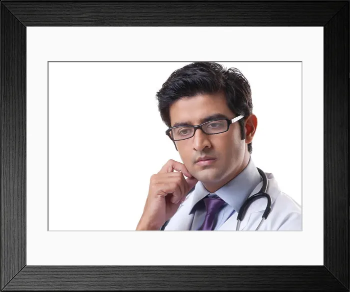 Framed Print : Thoughtful male doctor over white background Framed Print : Thoughtful male doctor over white background