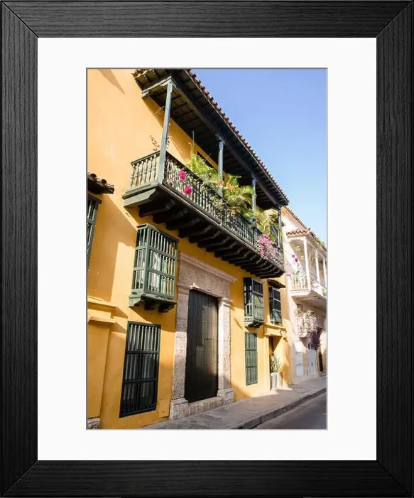 Framed Print : Sun shines on a yellow building in Old Town Cartagena Colombia Framed Print : Sun shines on a yellow building in Old Town Cartagena Colombia