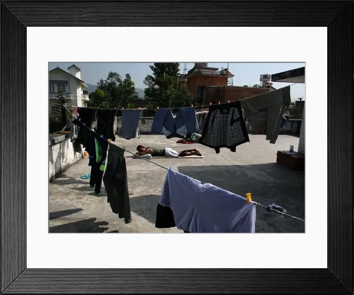 Framed Print : Bangladeshi people sleeping on a roof top surrounded by washed cloths drying on lines. Bangladesh Framed Print : Bangladeshi people sleeping on a roof top surrounded by washed cloths drying on lines. Bangladesh