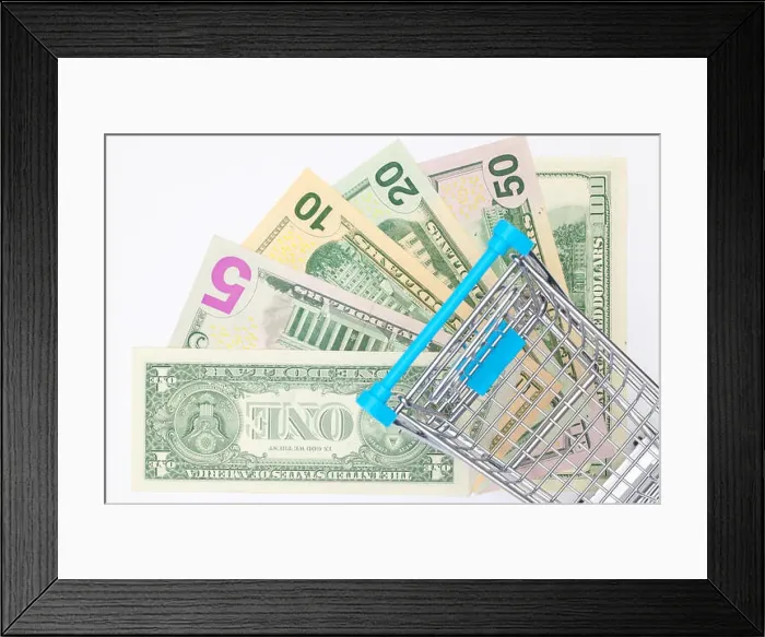 Framed Print : Different us dollar banknotes and empty shopping trolley. Flat lay photography Framed Print : Different us dollar banknotes and empty shopping trolley. Flat lay photography