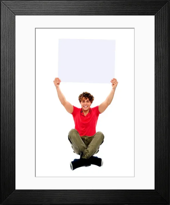 Framed Print : Trendy guy sitting with crossed legs holding white clipboard Framed Print : Trendy guy sitting with crossed legs holding white clipboard